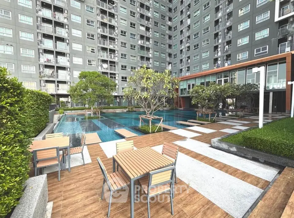 Modern apartment complex with pool and outdoor seating area