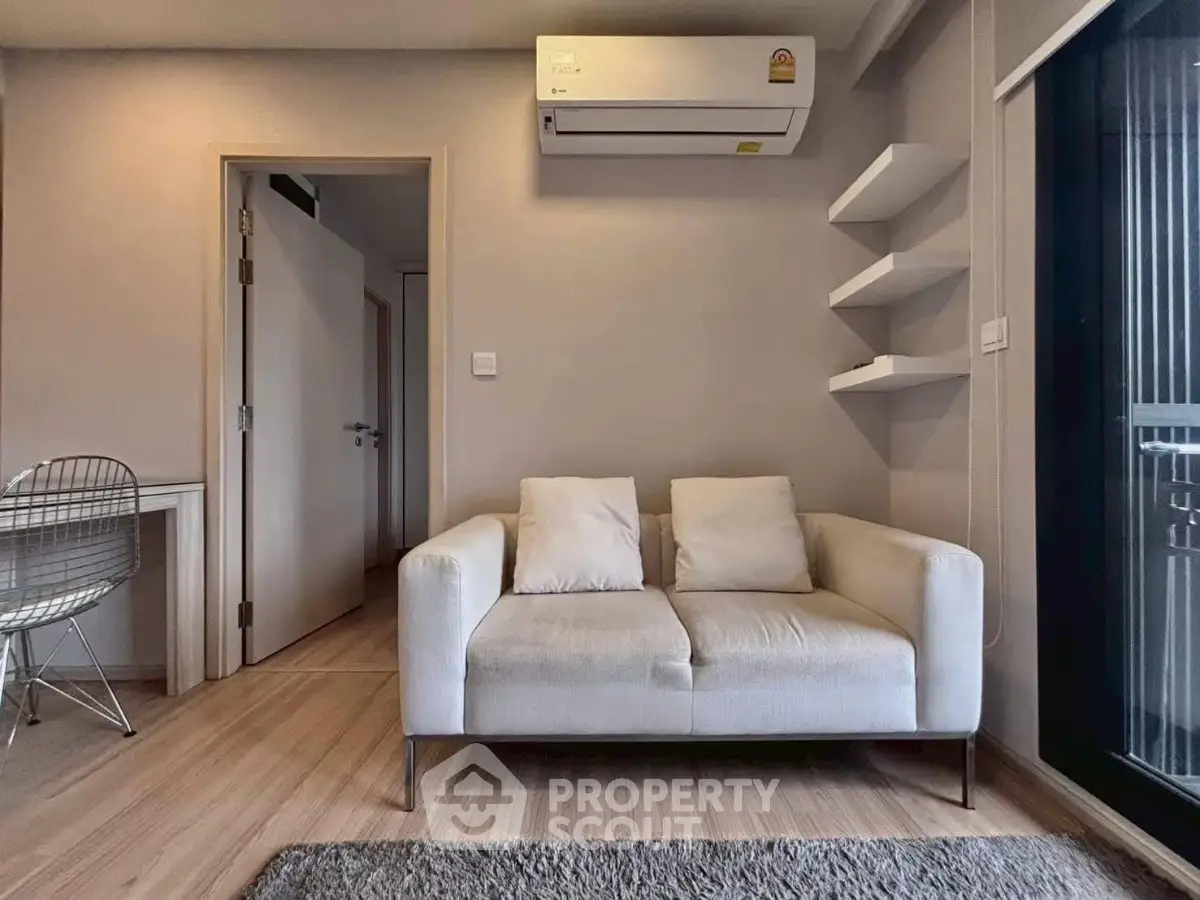 Modern living room with cozy white sofa and air conditioning, perfect for relaxation and comfort.