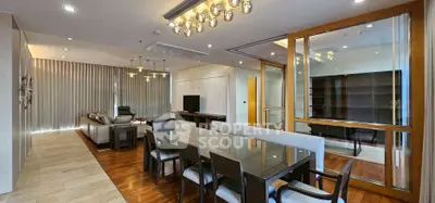 Luxurious open-plan living and dining area with modern lighting and elegant decor.
