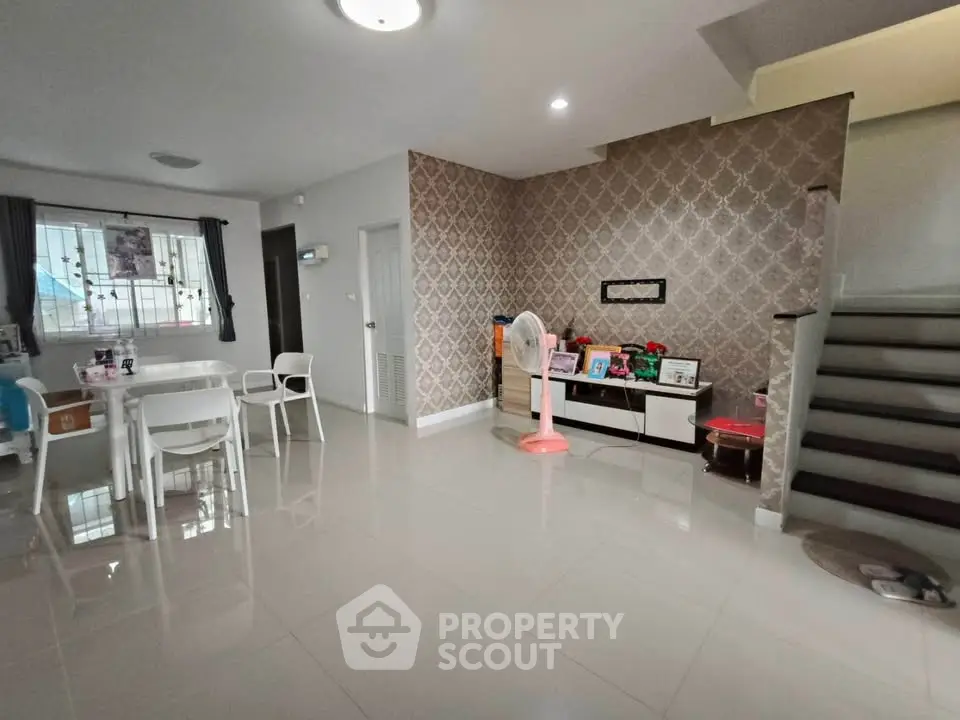 Spacious modern living area with elegant wallpaper and dining set