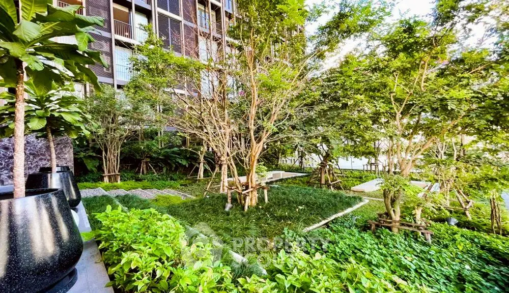 Lush green garden area in modern residential complex with vibrant landscaping.