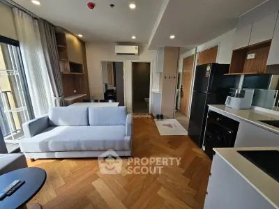 Modern living room with stylish furniture and open kitchen in a contemporary apartment.