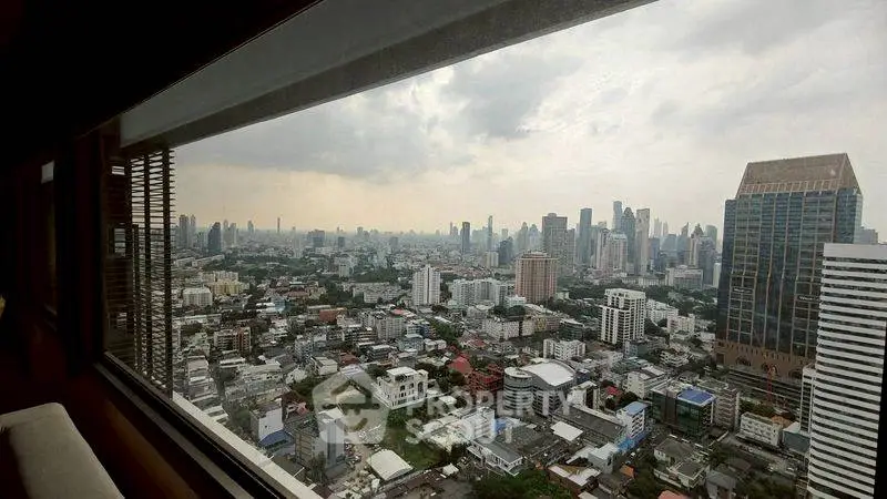 Stunning cityscape view from a high-rise window showcasing urban skyline and architecture.