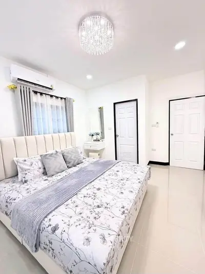 Elegant bedroom with modern decor, featuring a plush bed and stylish lighting, perfect for relaxation.