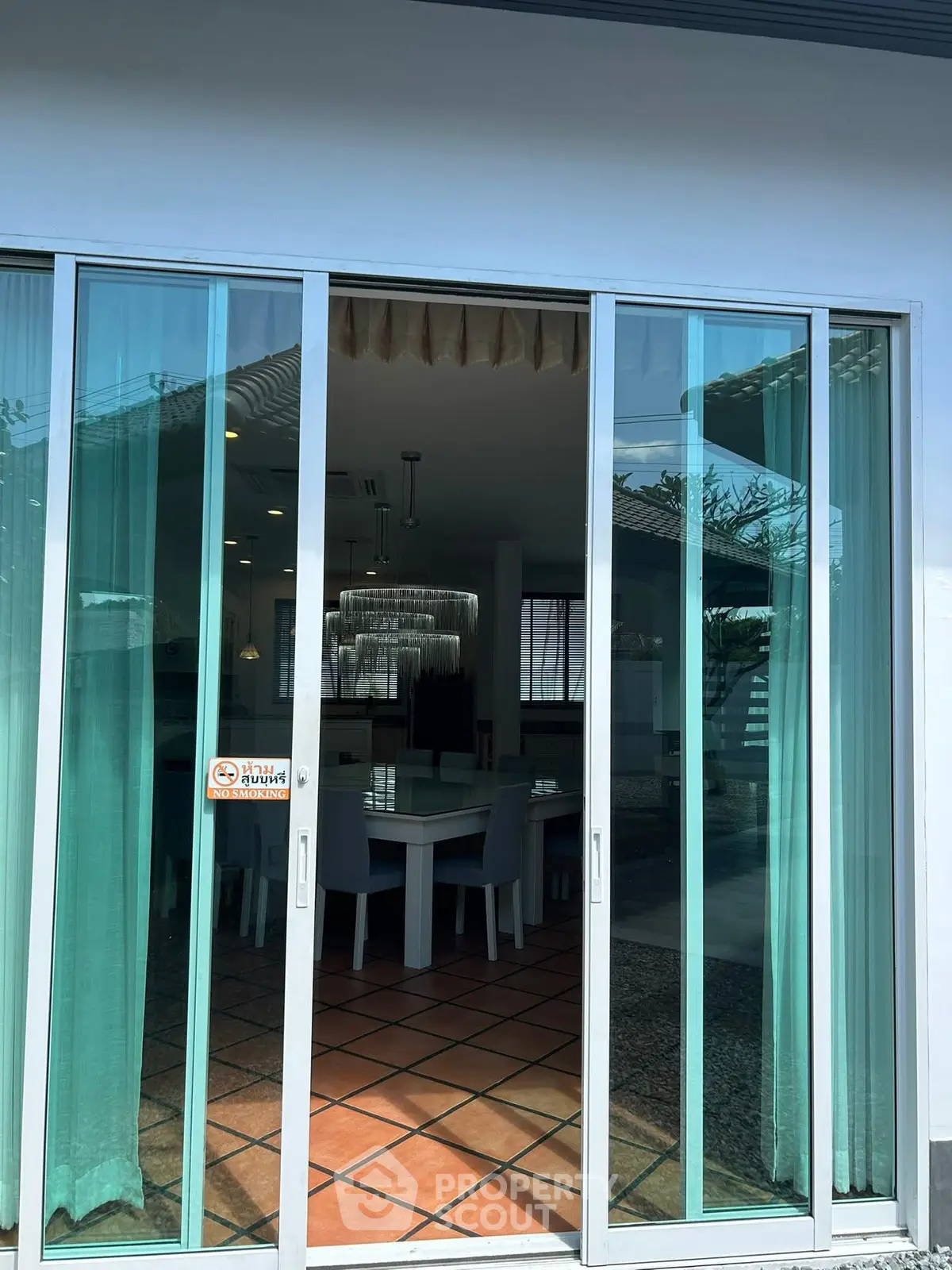 Elegant dining area with glass doors and chic chandelier in modern home