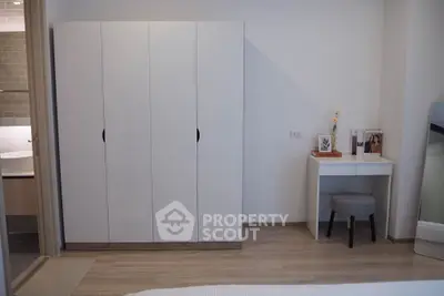 Modern bedroom with sleek wardrobe and stylish vanity desk, perfect for contemporary living.