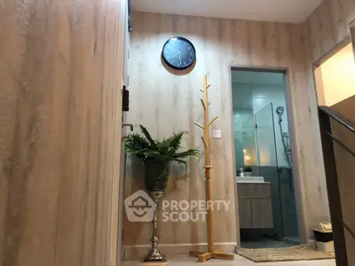 Modern hallway with elegant decor leading to a stylish bathroom
