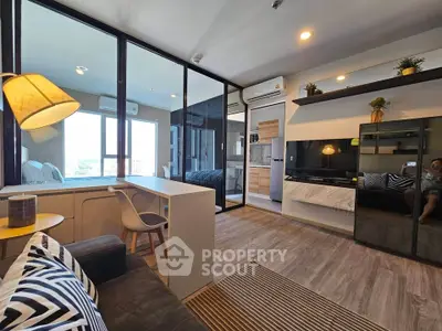 Modern living room with stylish decor and large windows offering natural light.