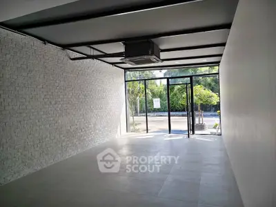Spacious commercial space with large windows and modern design, ideal for retail or office use.