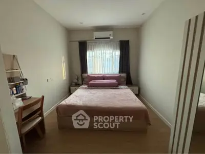 Cozy bedroom with natural light and modern furnishings, perfect for relaxation.