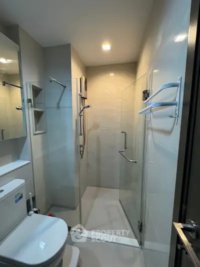 Modern bathroom with glass shower enclosure and sleek fixtures