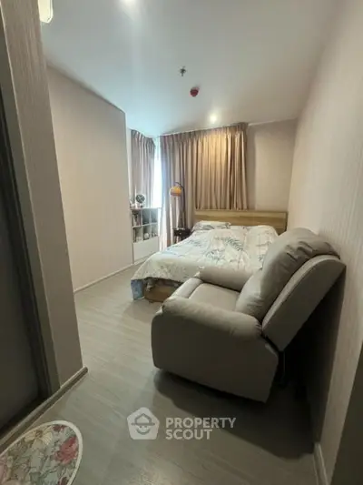 Cozy bedroom with modern decor and comfortable recliner chair