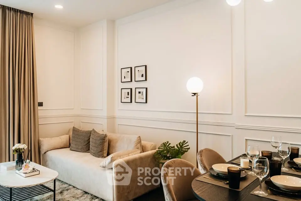 Elegant living room with modern decor, cozy sofa, and stylish dining area in a luxurious apartment.