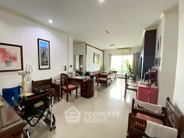 Spacious living room with elegant furniture and large windows offering natural light.