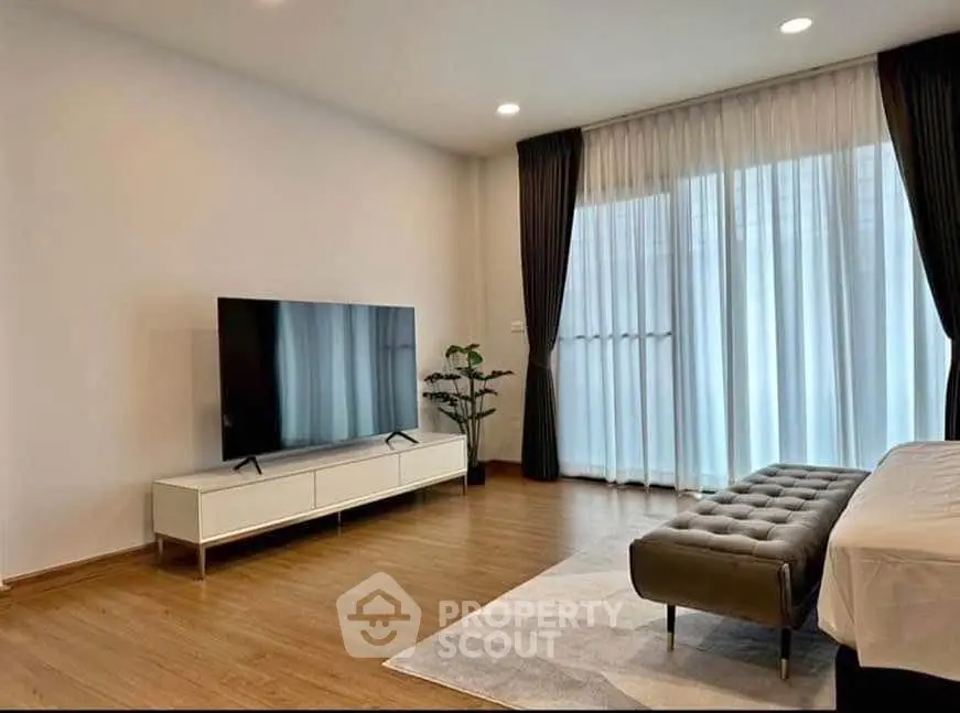 Spacious modern living room with large TV and elegant decor