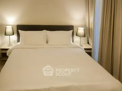 Cozy bedroom with elegant lighting and plush bedding for a restful retreat.