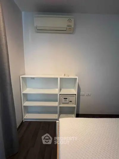 Cozy bedroom with air conditioning and modern shelving unit
