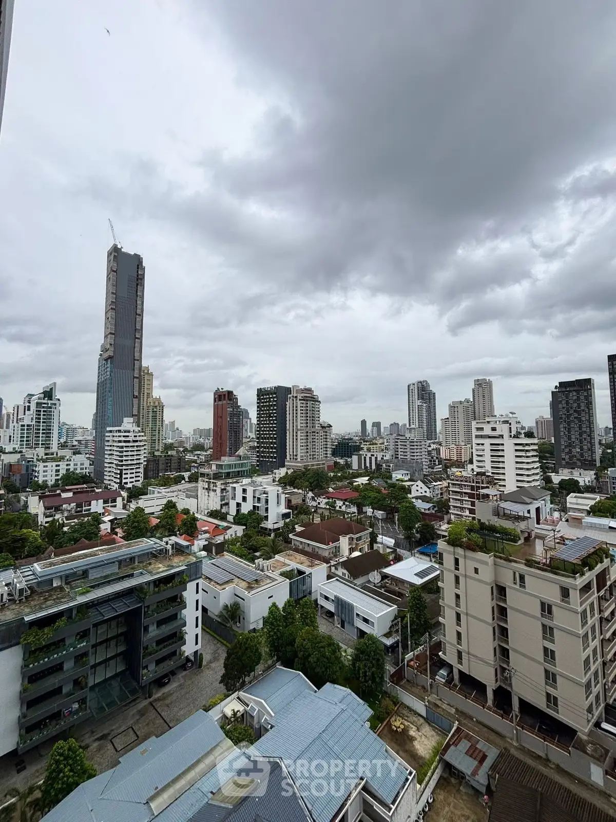 Stunning cityscape view from a high-rise building showcasing urban skyline and modern architecture.