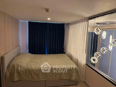Cozy bedroom with modern lighting and large window view
