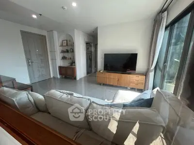 Spacious living room with modern decor and large windows for natural light.
