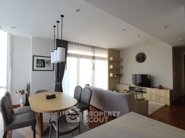 Spacious modern living room with elegant dining area and natural light