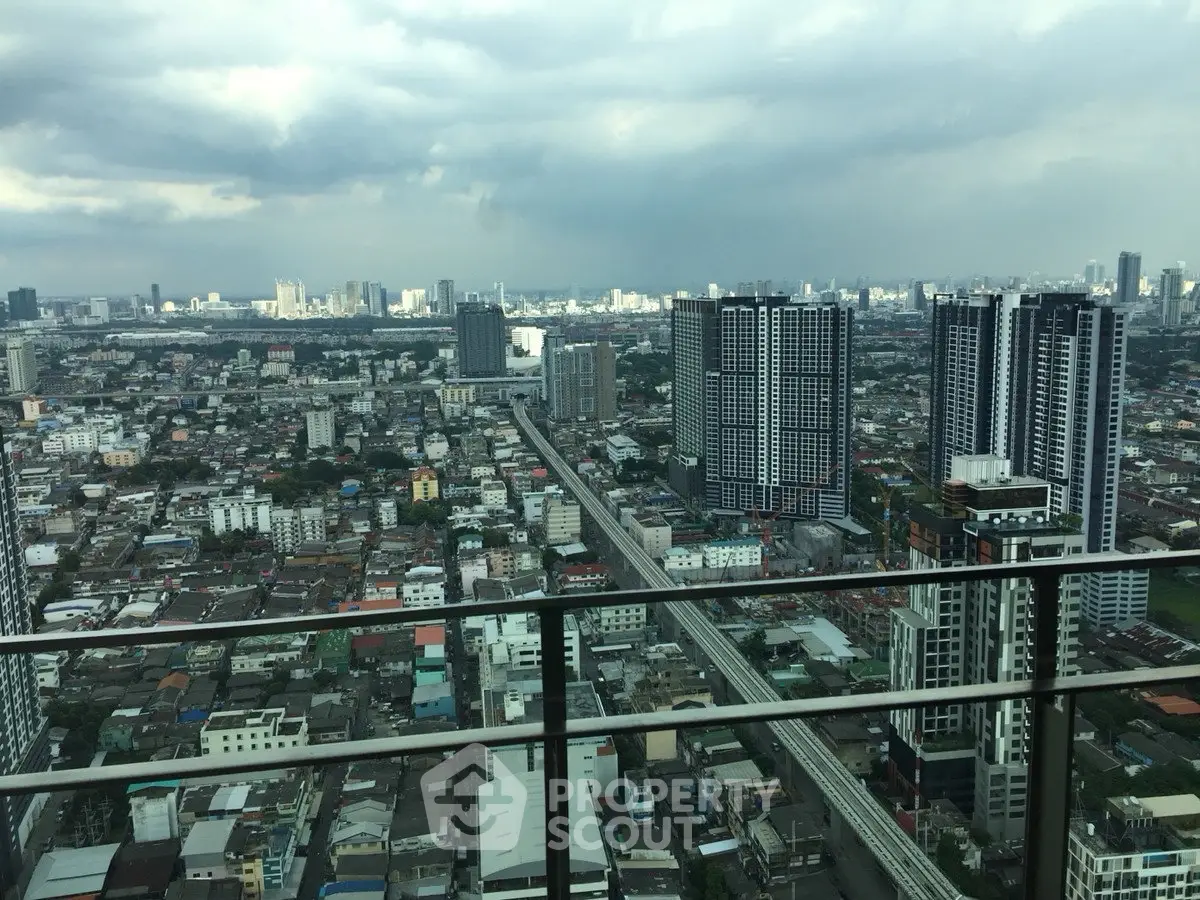 Stunning cityscape view from high-rise balcony overlooking urban skyline and bustling streets.