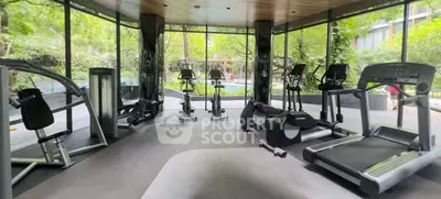 Modern gym with state-of-the-art equipment and lush garden views.
