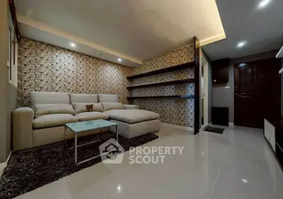 Modern living room with stylish wallpaper and cozy sectional sofa