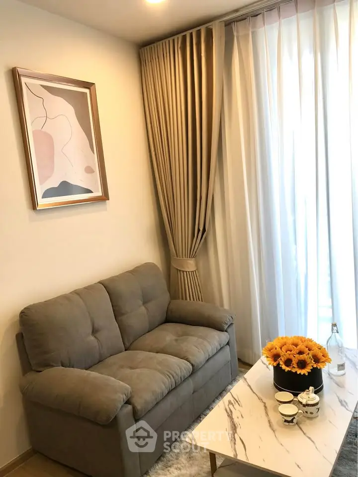 Cozy living room with plush sofa, elegant curtains, and stylish decor.