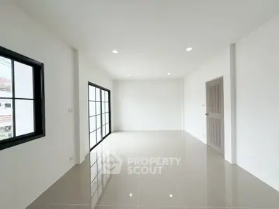 Spacious and bright empty room with large windows and glossy tiled floor, perfect for customization.