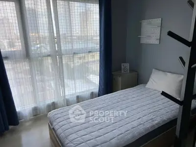 Cozy bedroom with large window and modern decor in urban apartment