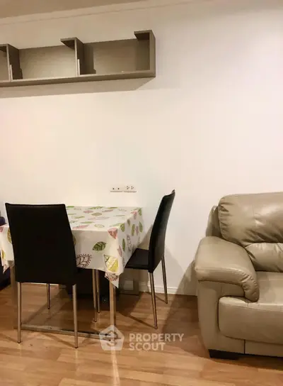 Cozy living room with modern furniture and dining area, perfect for small gatherings.