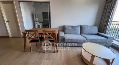 Modern living room with cozy sofa, dining table, and natural light.