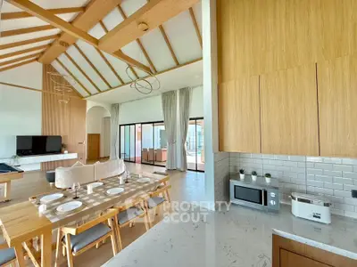 Spacious open-plan living and dining area with modern kitchen and high ceilings