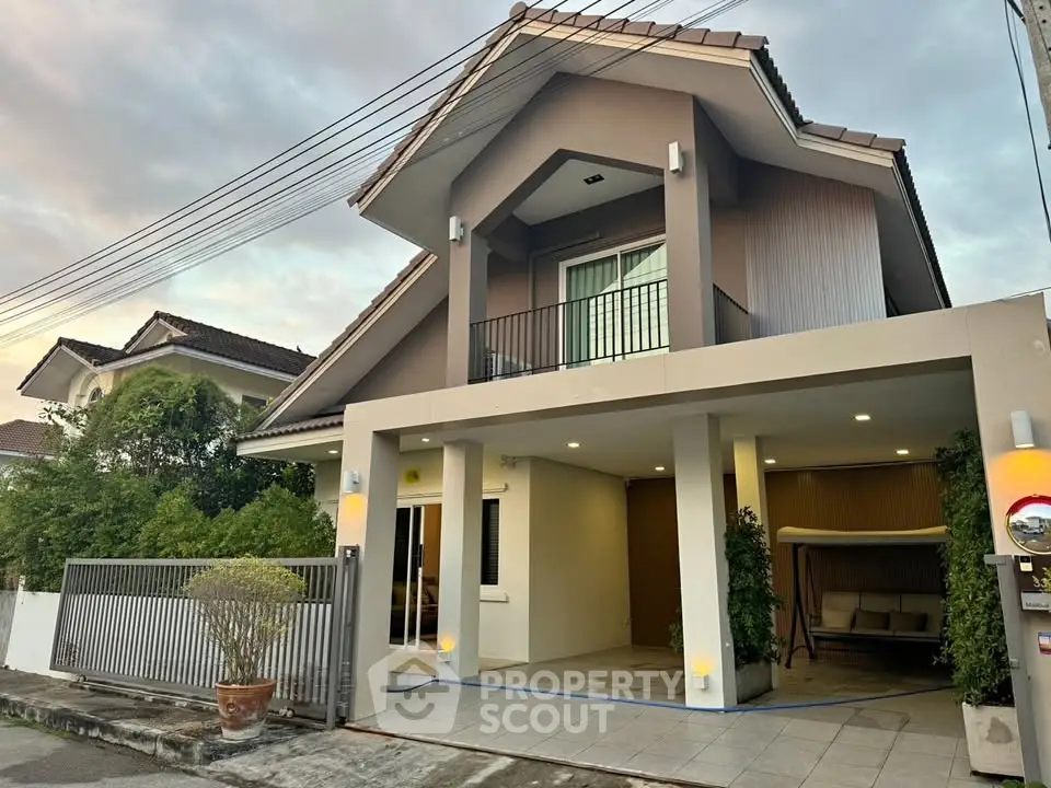 Charming two-story house with a modern facade, spacious balcony, and inviting entrance in a serene neighborhood.