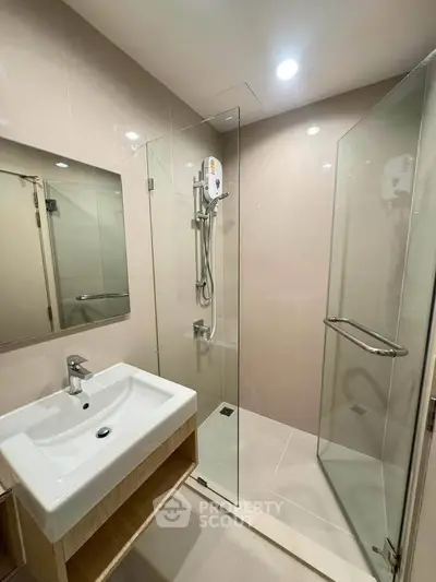 Modern bathroom with glass shower enclosure and sleek sink design