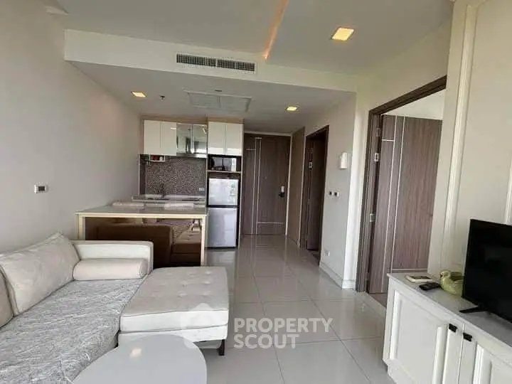 Modern living room with open kitchen and sleek furniture in a stylish apartment.