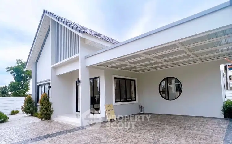 Modern white house exterior with spacious carport and stylish architecture.