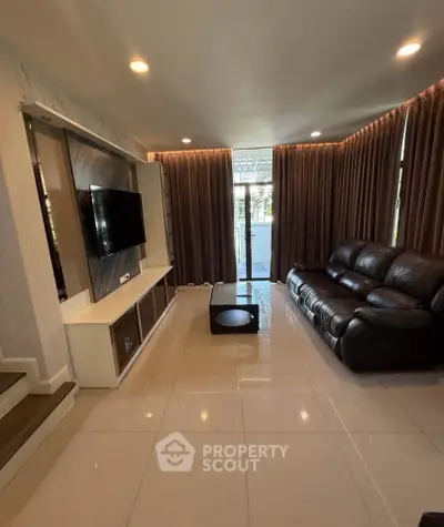 Spacious living room with modern decor and large windows for natural light.