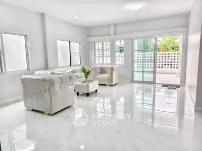 Spacious living room with modern furniture and large windows for natural light.