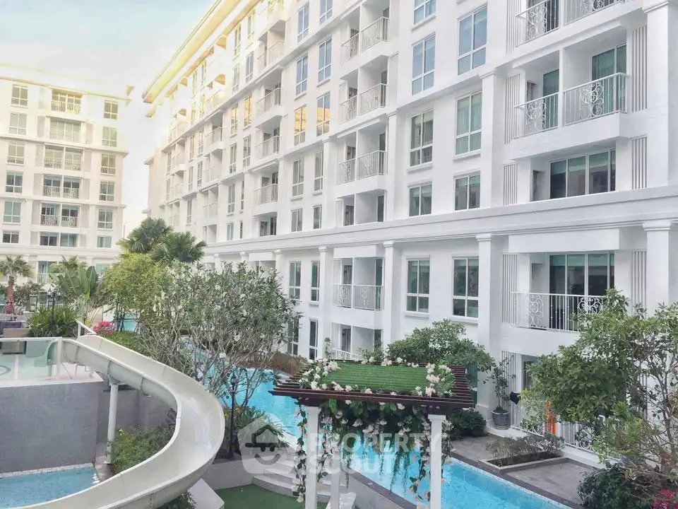 Luxurious condominium with pool view and elegant balconies in a modern residential complex.