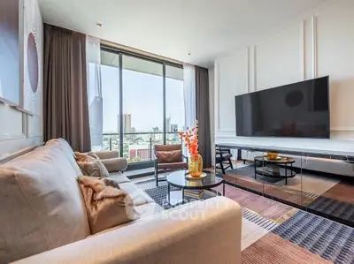 Spacious modern living room with large TV and city view, perfect for relaxation and entertainment.