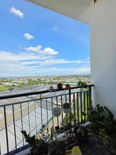 Stunning balcony view with lush greenery and expansive cityscape, perfect for relaxation and enjoying nature.