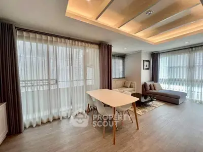 Spacious modern living room with elegant dining area and large windows for natural light.