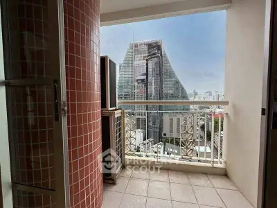 Stunning city view from a high-rise balcony with modern architecture.