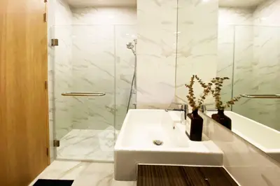 Elegant modern bathroom with glass shower and stylish sink