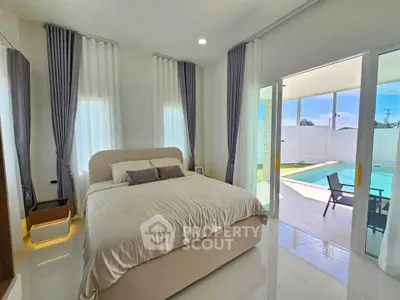 Luxurious bedroom with pool view and elegant decor in modern home