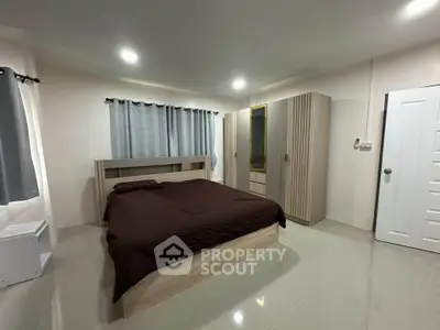 Spacious bedroom with modern furnishings and ample natural light