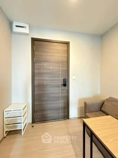 Modern apartment entrance with wooden door and cozy seating area