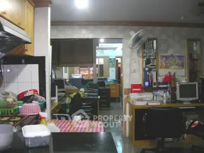 Cozy kitchen and study area with eclectic decor and homey atmosphere.